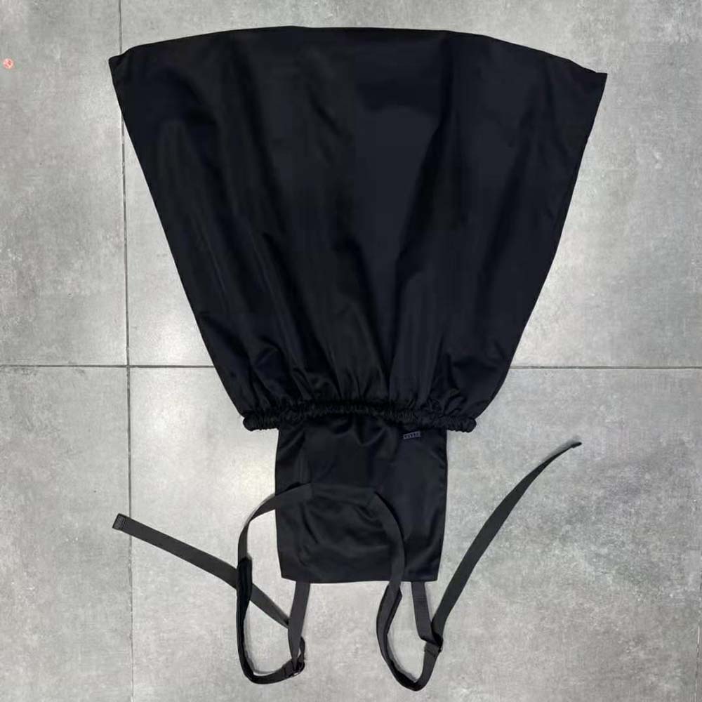 Side angle showing tailored silhouette of Prada Re-Nylon pinafore dress