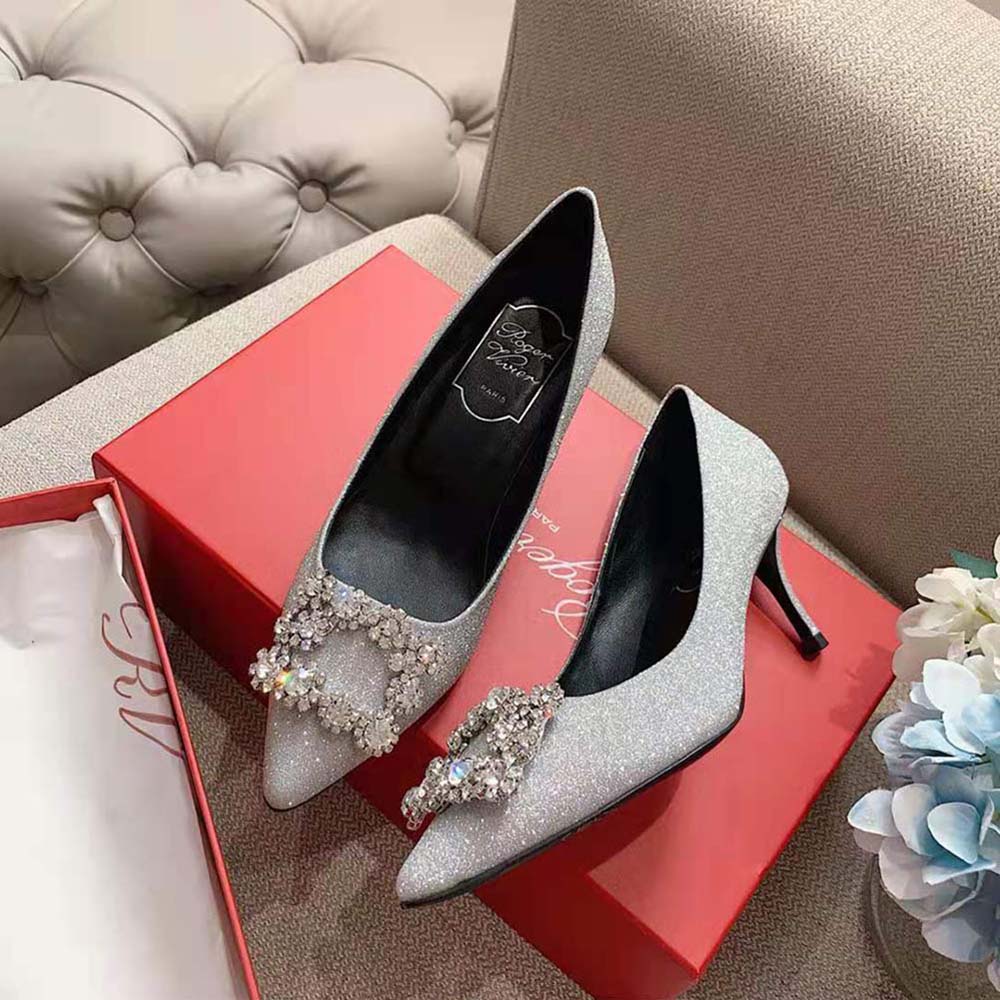 Side profile showing high heel silhouette of Roger Vivier flower buckle pumps
