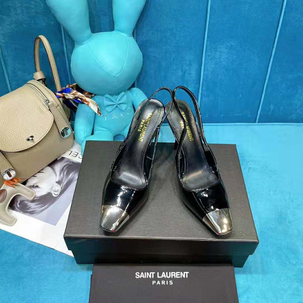 Close-up of gold YSL hardware on the slingback strap of Saint Laurent pumps