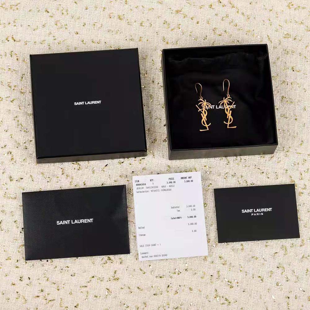 Close-up detail of YSL monogram and palm motif on earrings