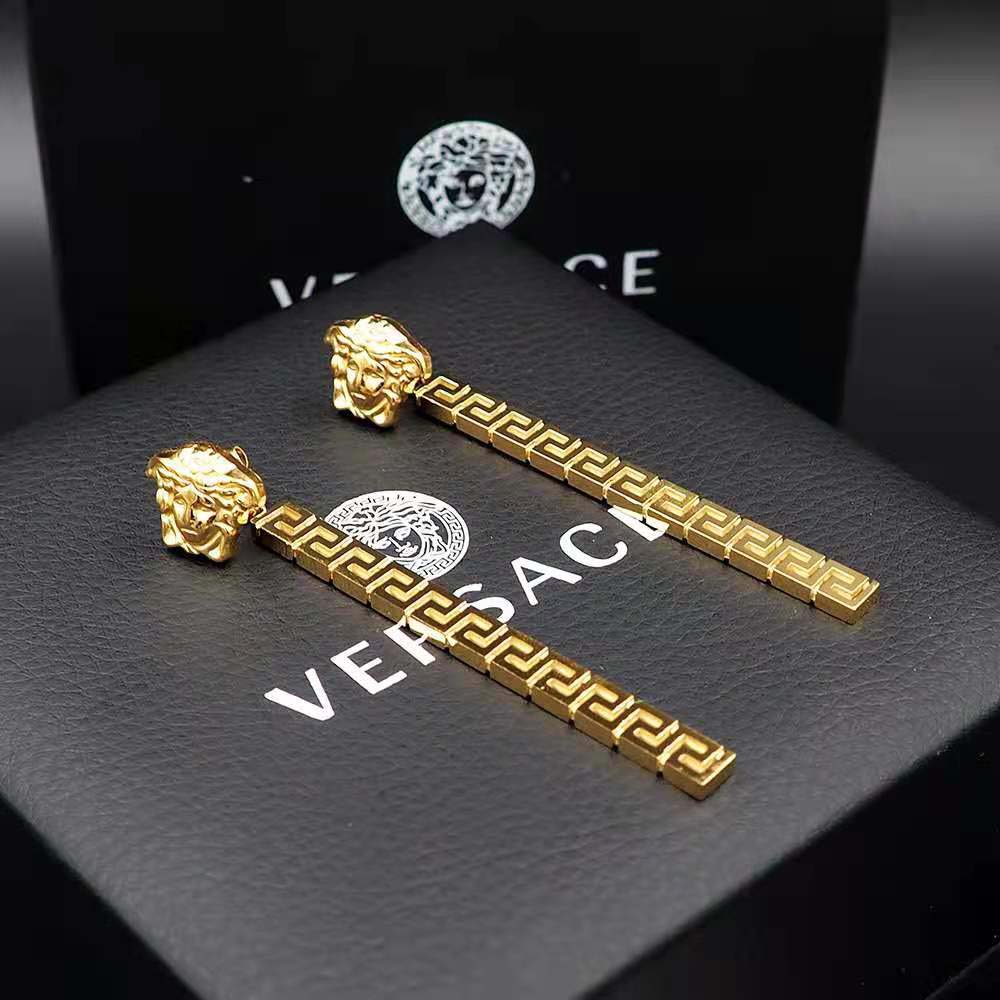 Close-up of polished gold finish on Versace Women Greca Drop Earrings-Gold