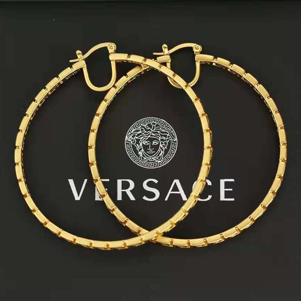 Versace Women Greca Hoop Earrings-Gold styled on model’s ear