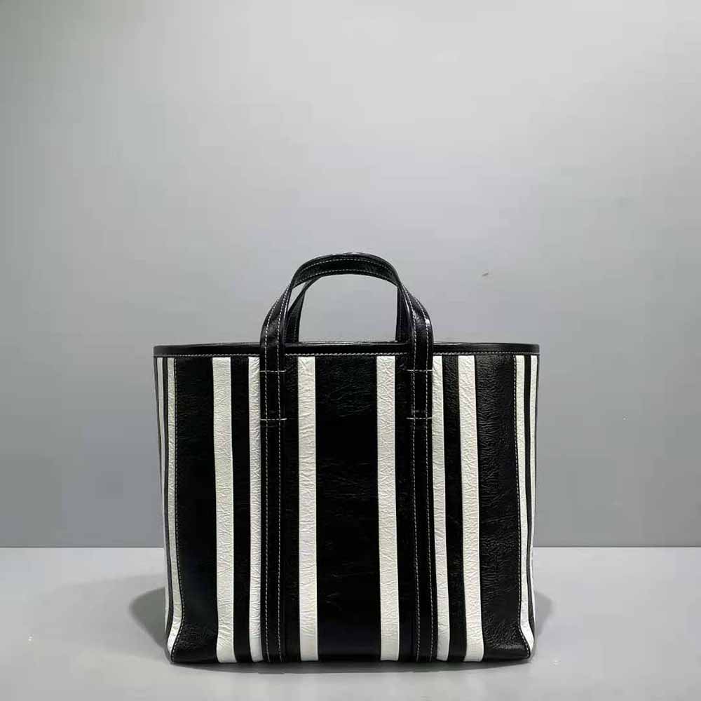 Side angle showing silhouette of Balenciaga Women Barbes Medium East-West Shopper Bag-Black