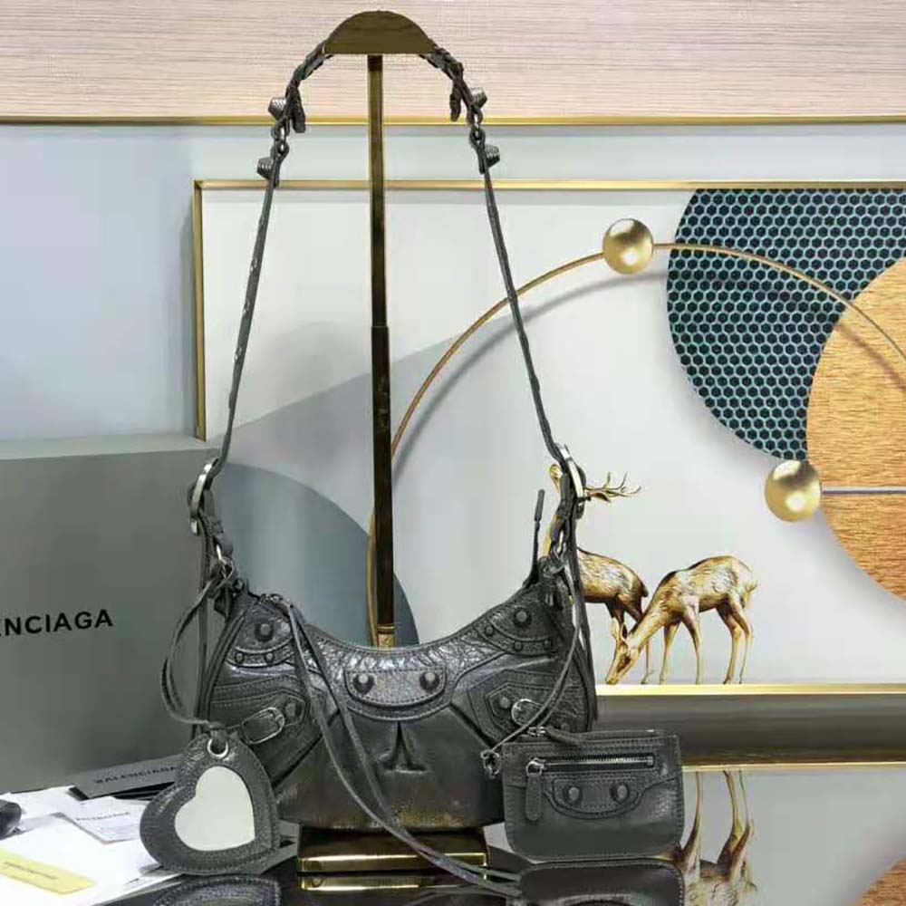 Close-up on aged brass hardware of Balenciaga Women Le Cagole XS Shoulder Bag-Black