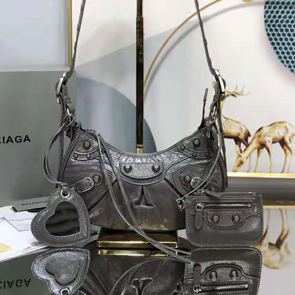 Side angle showing compact shape of Balenciaga Women Le Cagole XS Shoulder Bag-Black