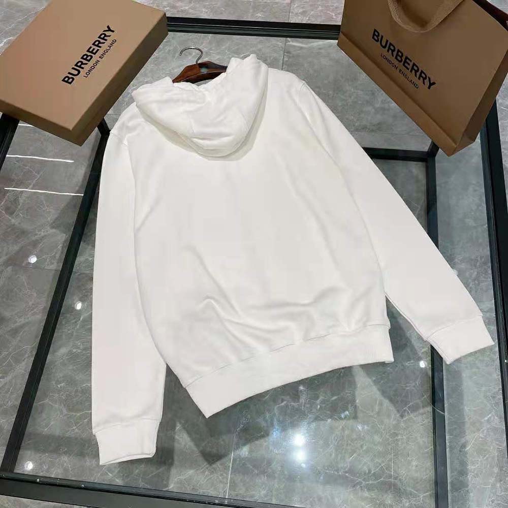 Side angle showing zip closure and hood of Burberry white cotton top