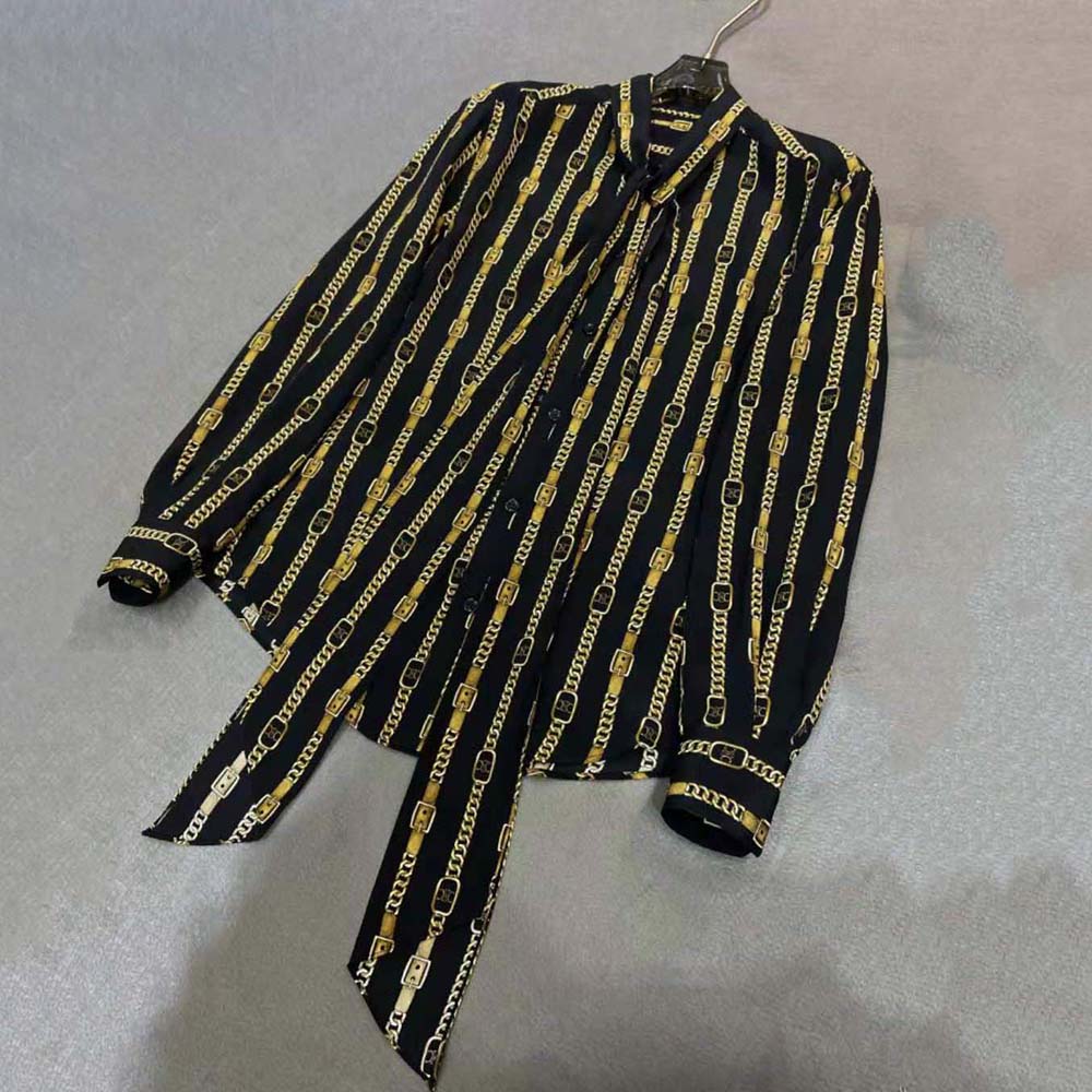 Close-up of button and fabric texture on Celine black loose shirt