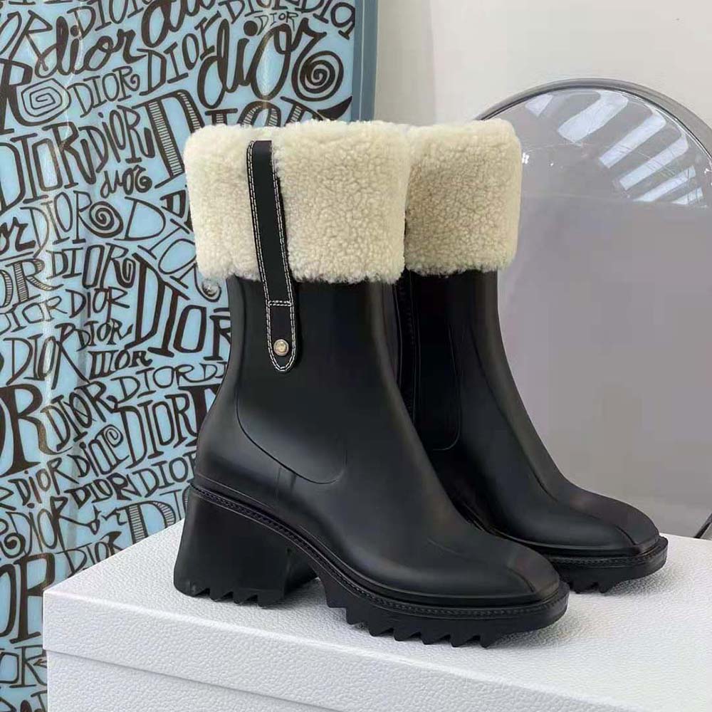 Close-up of glossy PVC and embossed logo on Chloe Betty Rain Boot