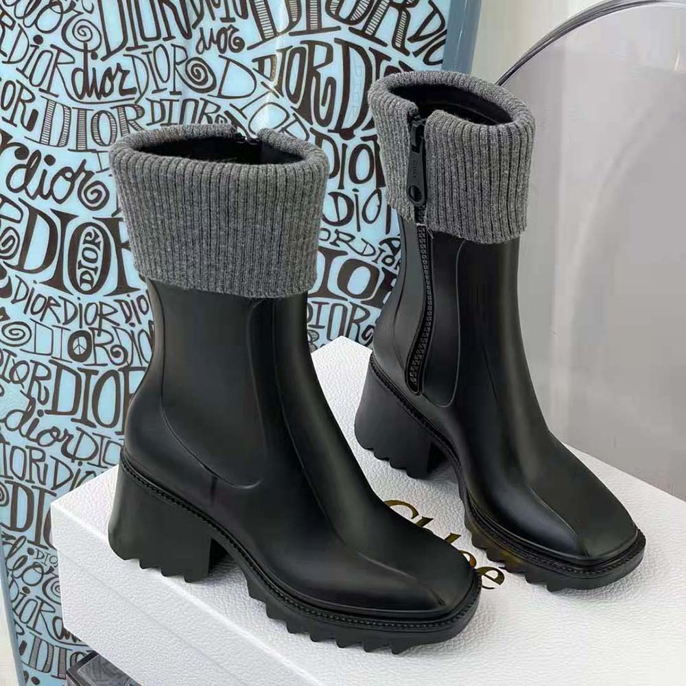 Close-up of glossy black PVC material and embossed Chloé logo on rain boot