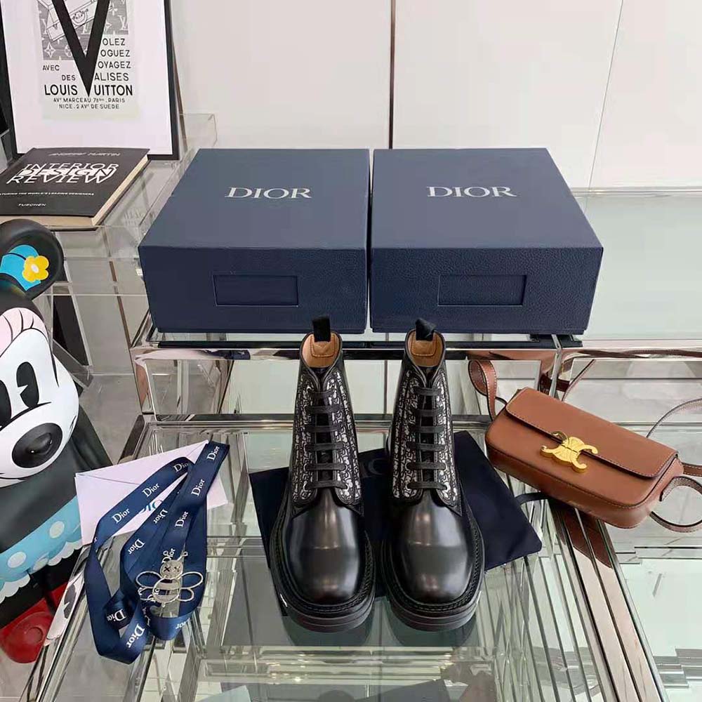 Close-up of lacing and embossed Dior hardware on the boot