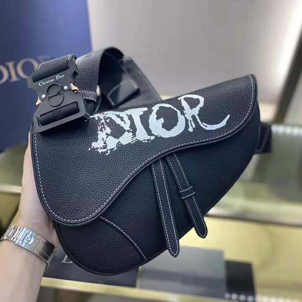 Side profile showing adjustable strap of Dior Men Peter Doig Saddle Bag