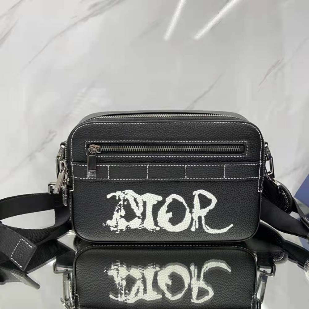 Side view showing adjustable strap and slim profile of Dior Men Peter Doig Safari Messenger Bag
