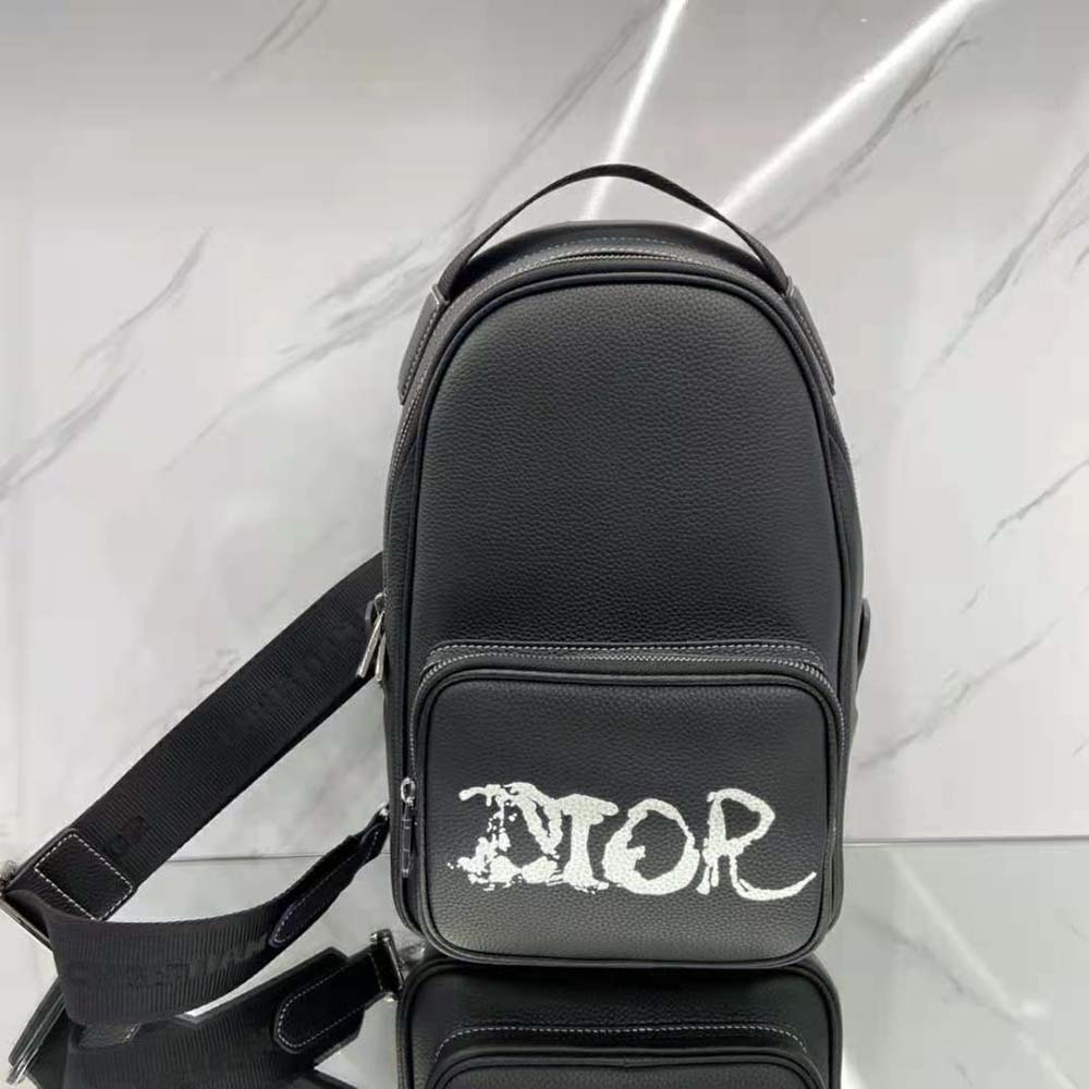 Close-up on silver hardware detail of Dior Men Peter Doig Sling Bag