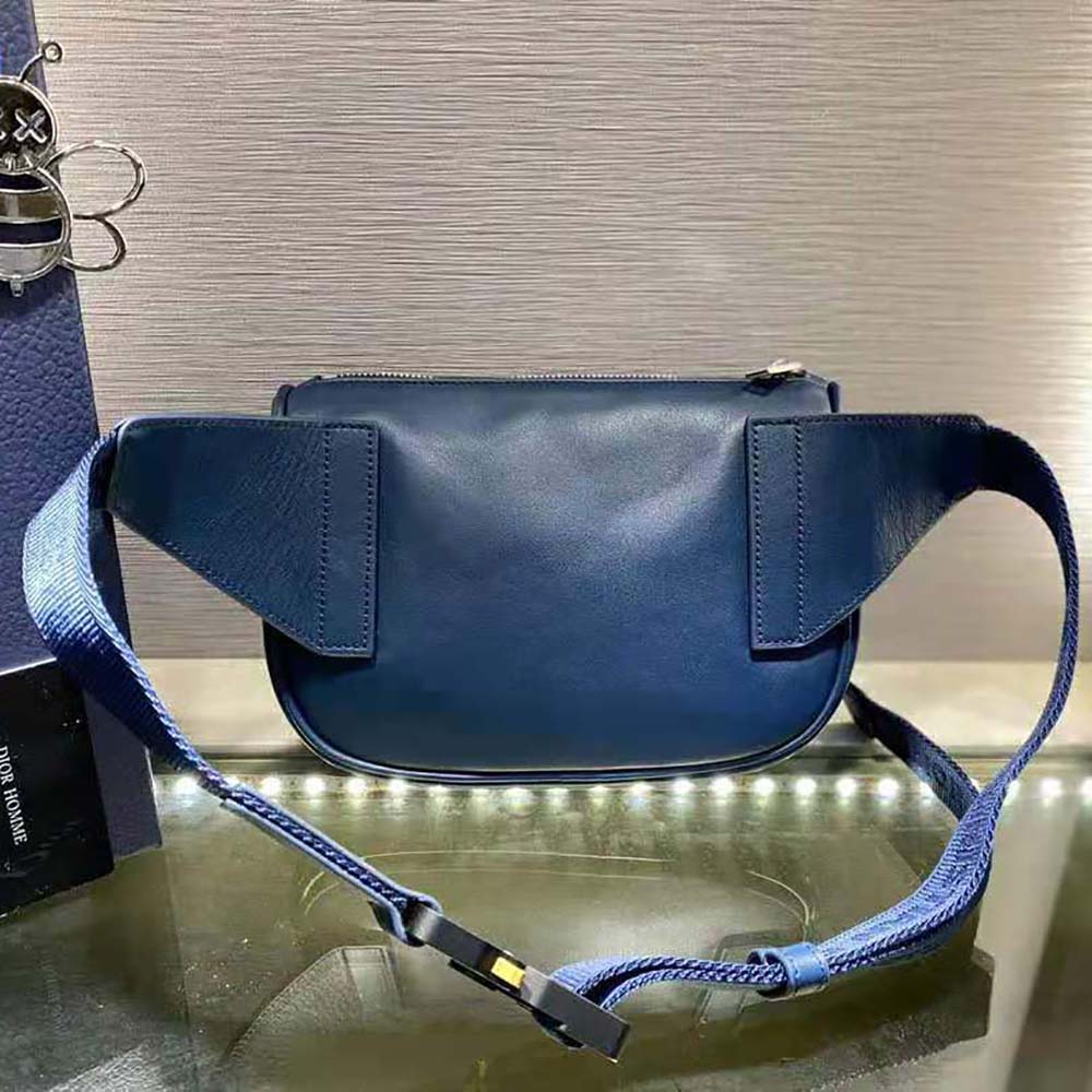 Side angle showing adjustable belt strap on Dior Men World Tour Saddle Belt Bag
