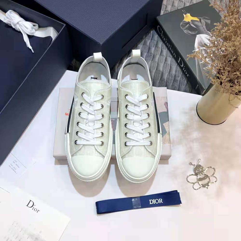Close-up of Dior logo hardware on white Dior Men B23 Low-Top Sneaker