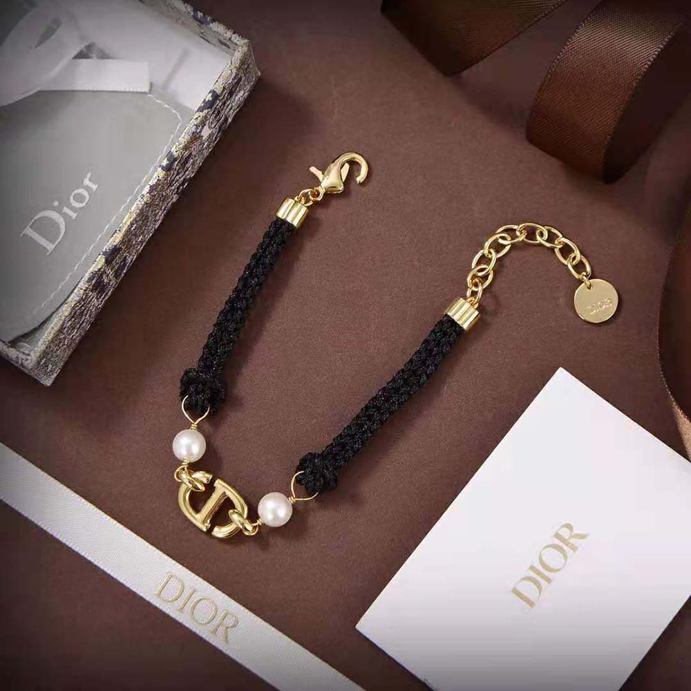 Styled shot of Dior Women CD Navy Bracelet highlighting pearl and charm detail