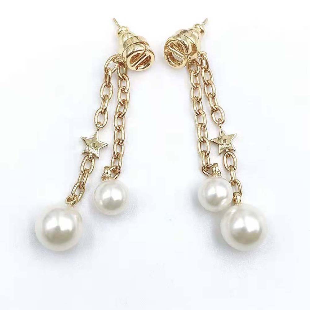 Close-up of signature Dior CD detail on earrings