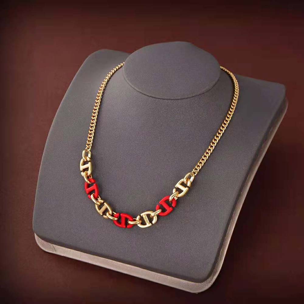 Close-up of Dior Women CD Navy Necklace raspberry lacquer detail and gold finish