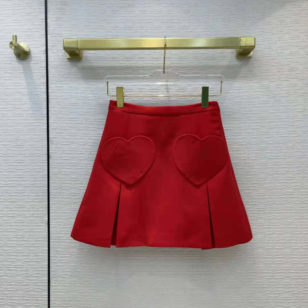 Close-up of heart-shaped pockets on Dior Women Dioramour red wool and silk miniskirt