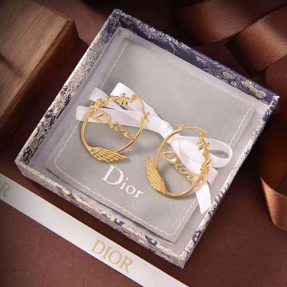 Close-up of signature Dior logo on gold-finish metal Dio(r)evolution Earrings