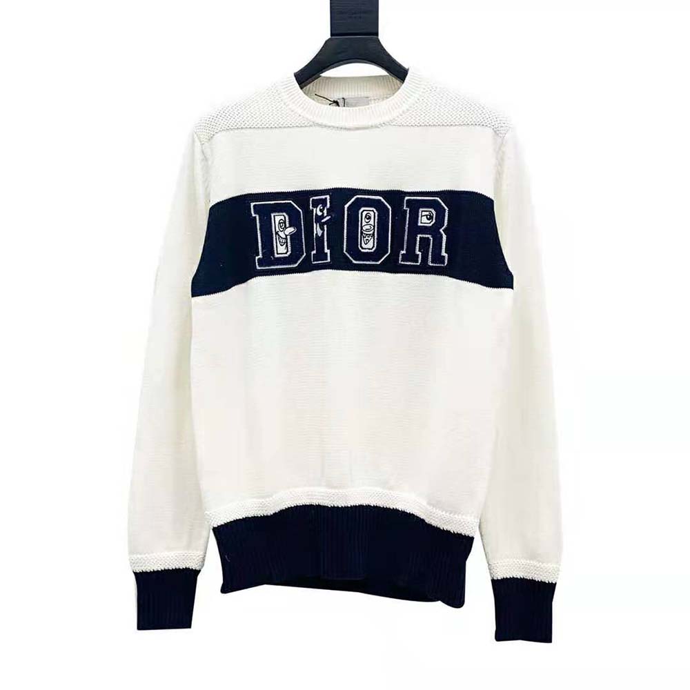 Close-up of signature Kenny Scharf print on white Dior sweater