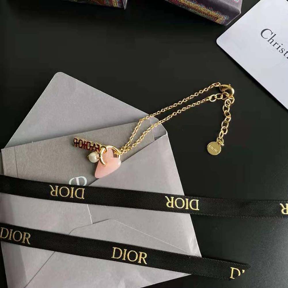 Styled wrist wearing Dior Women Le Coeur DE Dior Bracelet in natural light