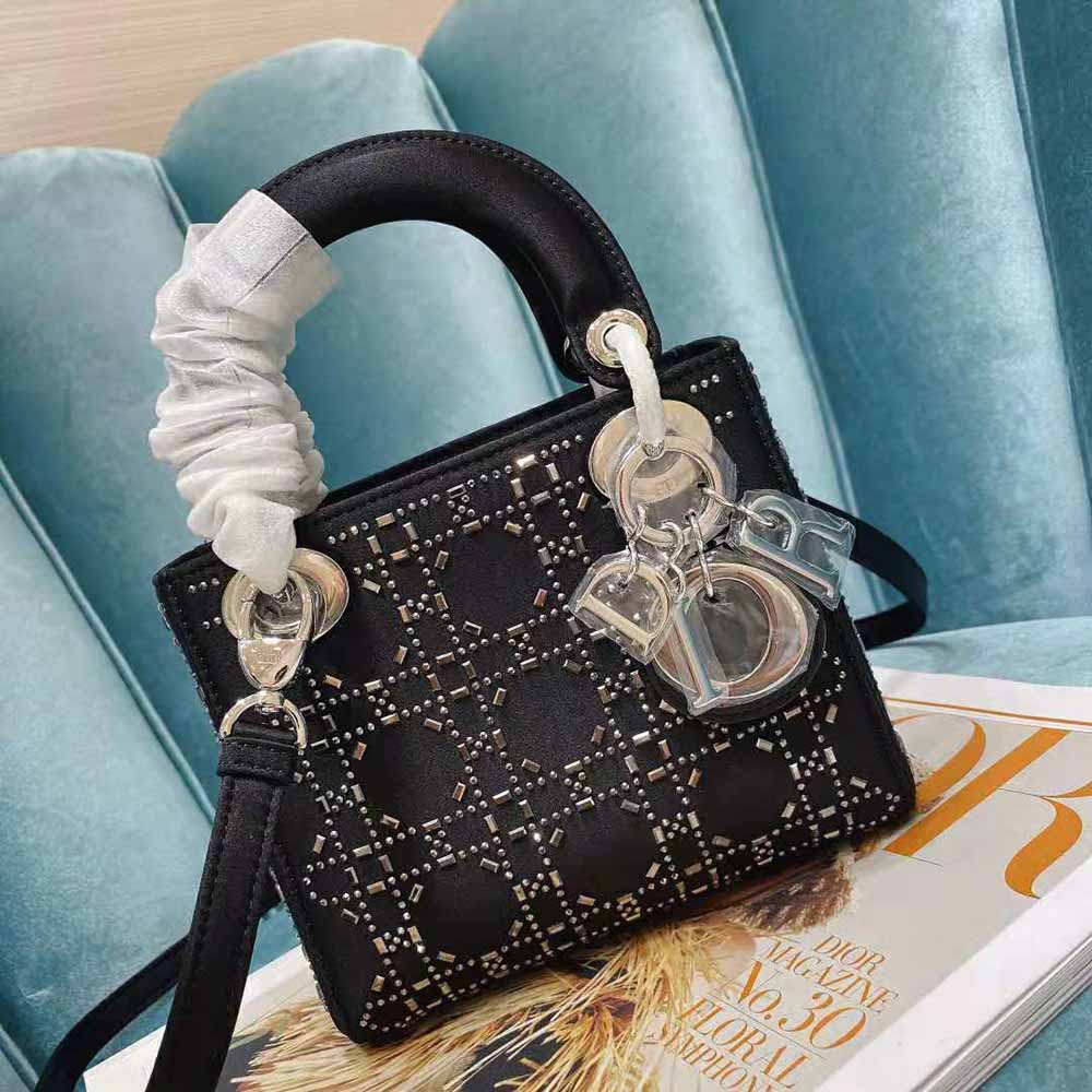 Side angle showing silver hardware and structured silhouette of Mini Lady Dior Bag