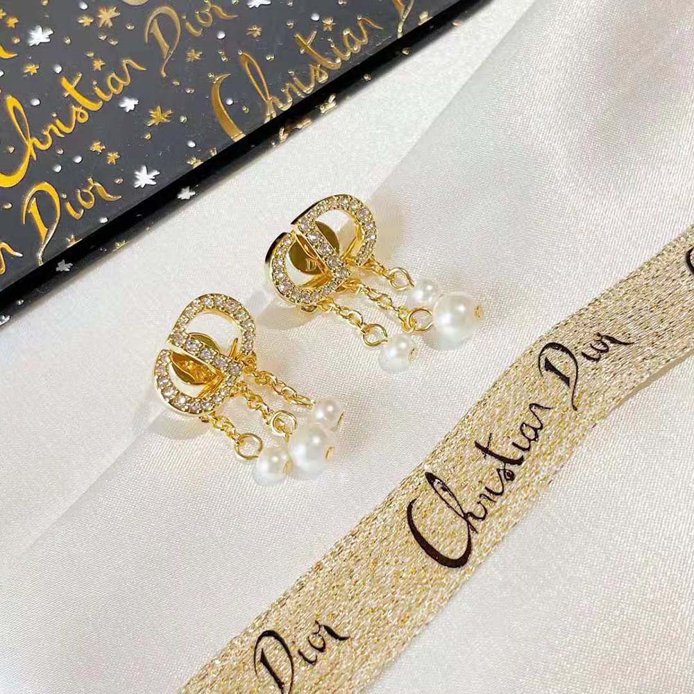 Side view showing Dior Women Petit CD Earrings delicate white crystals