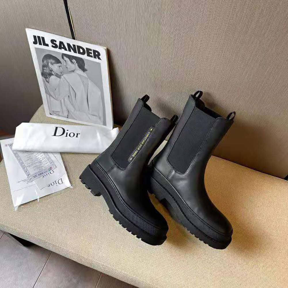 Close-up of signature Dior silver hardware on black calfskin boot
