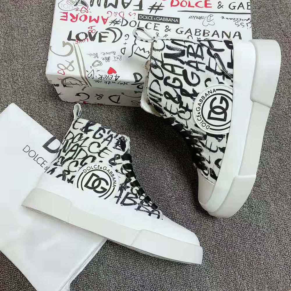 Close-up of DG logo print on black canvas mid-top sneakers