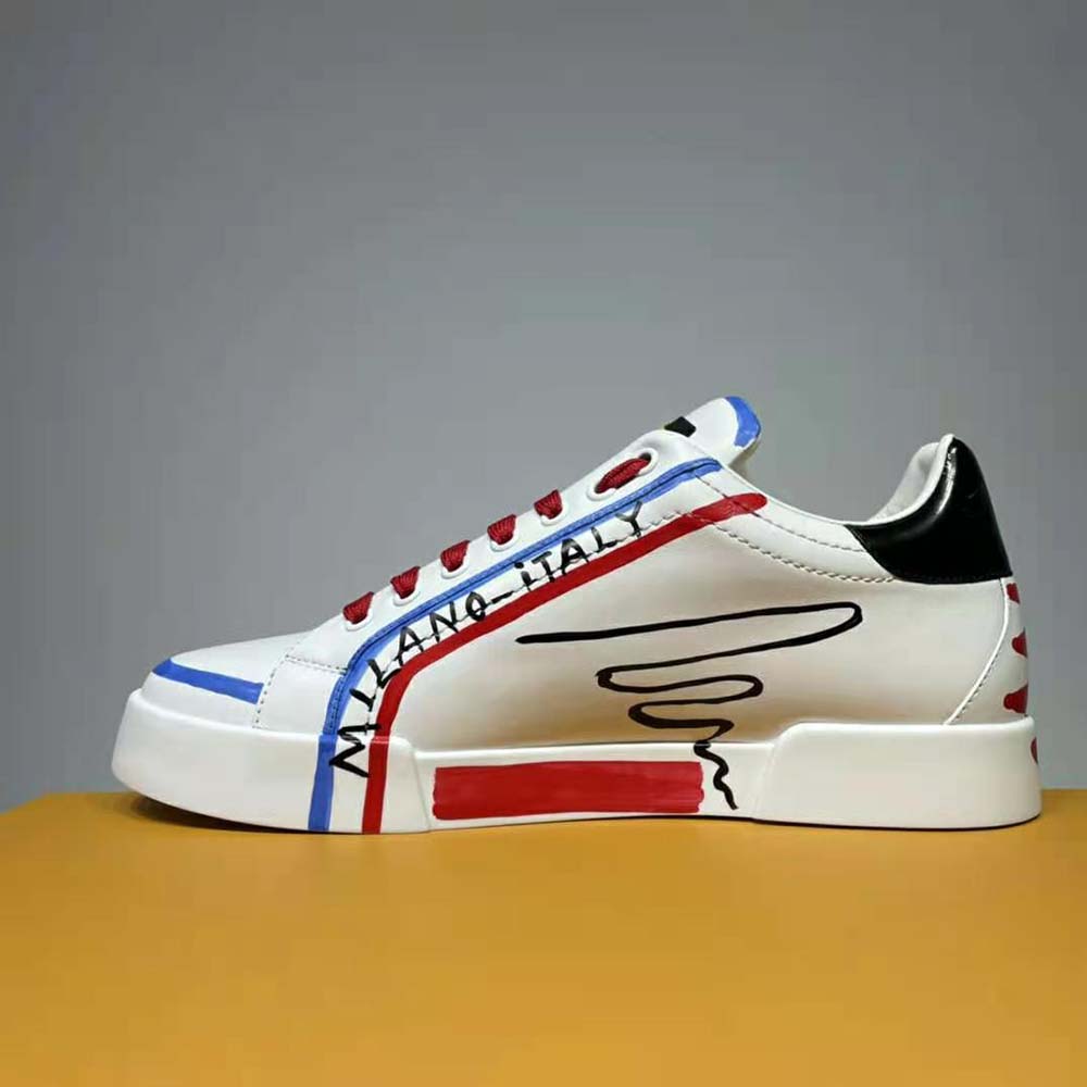 Close-up of blue leather and D&G embossed hardware on sneakers