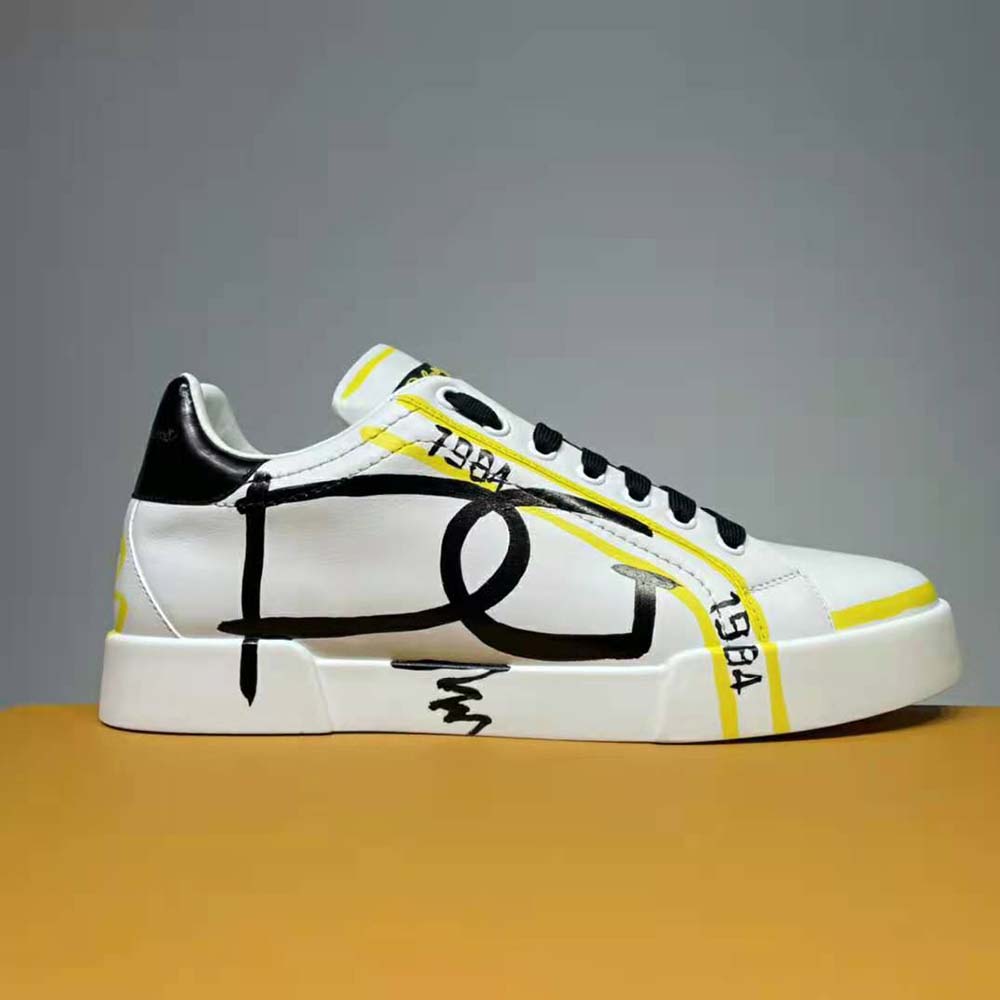 Close-up of yellow leather and D&G logo on Portofino Sneakers