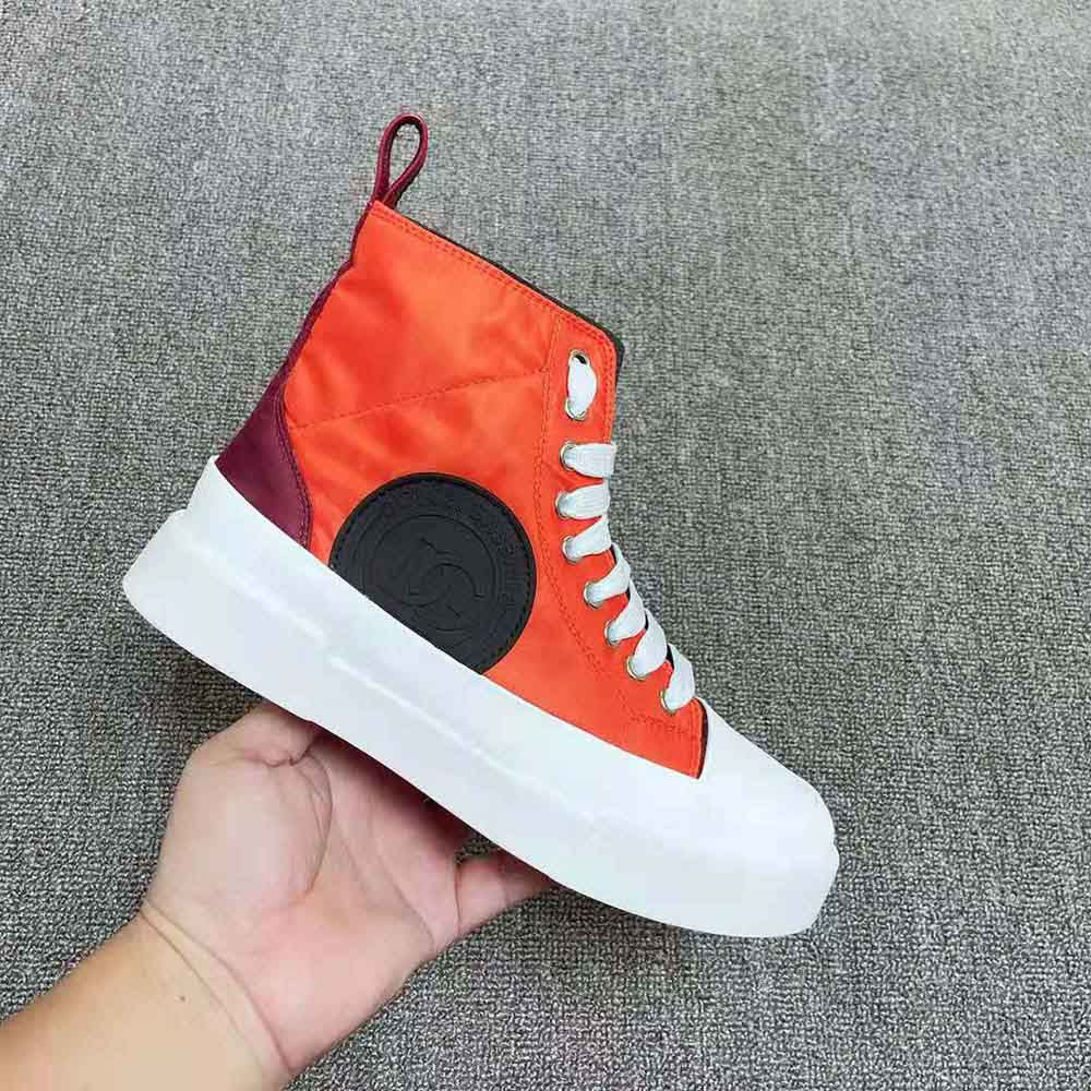 Close-up detail of orange nylon quilted upper on Dolce Gabbana D&G Portofino sneakers