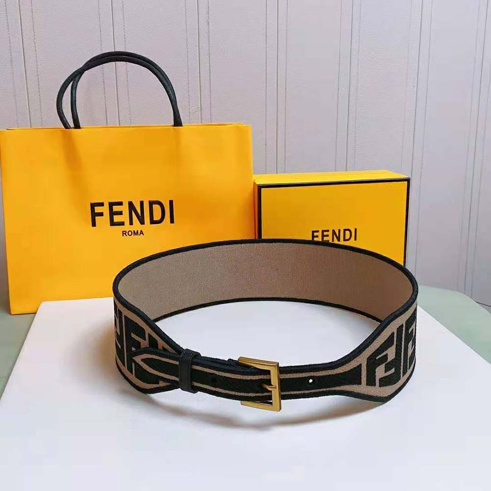 Close-up of textured brown canvas and signature Fendi logo buckle