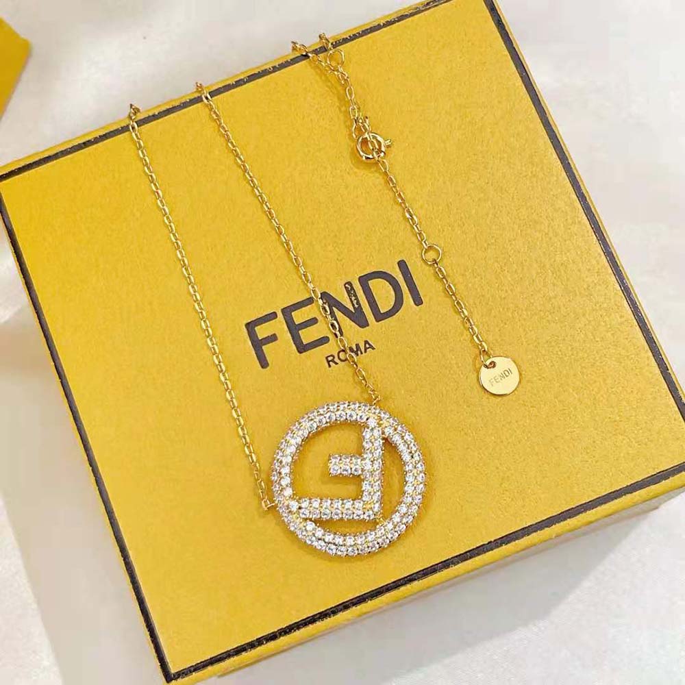 Close-up detail of gold-tone Fendi logo on the necklace chain