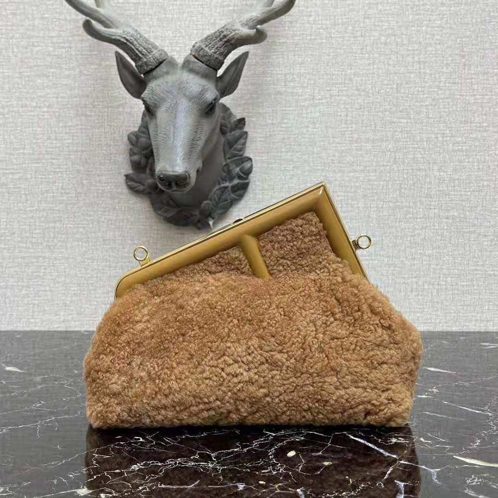 Close-up of gold hardware detail on Fendi Women First Medium Beige Sheepskin Bag