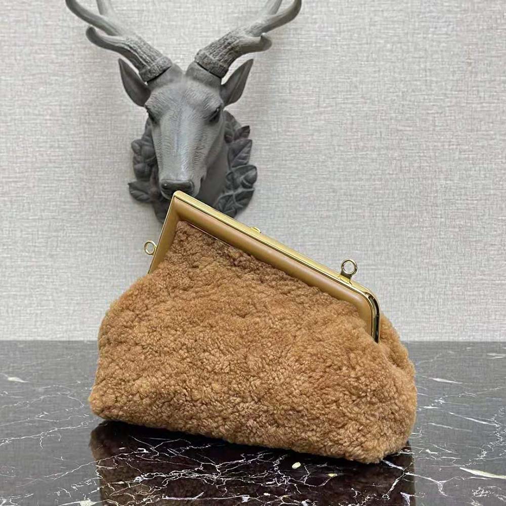 Side profile showing silhouette of Fendi Women First Medium Beige Sheepskin Bag