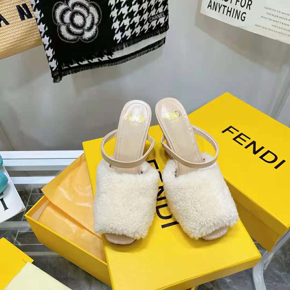 Close-up of gold hardware on Fendi Women First White Sheepskin Sandals