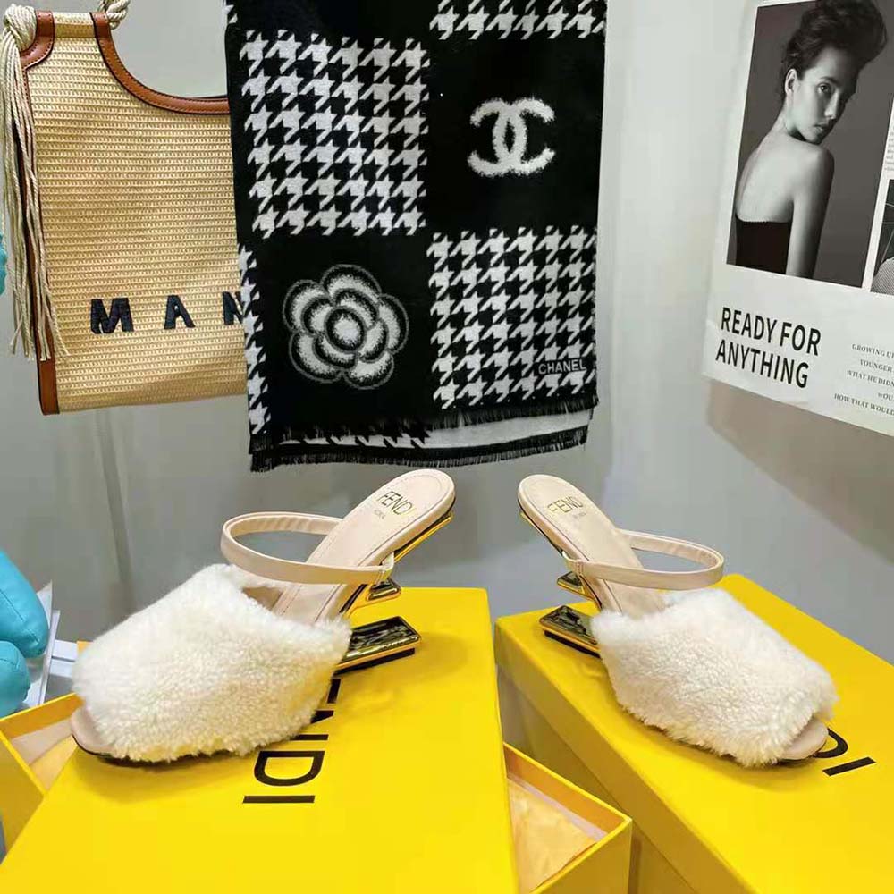 Front angle showing stiletto heel of Fendi Women First White Sheepskin Sandals