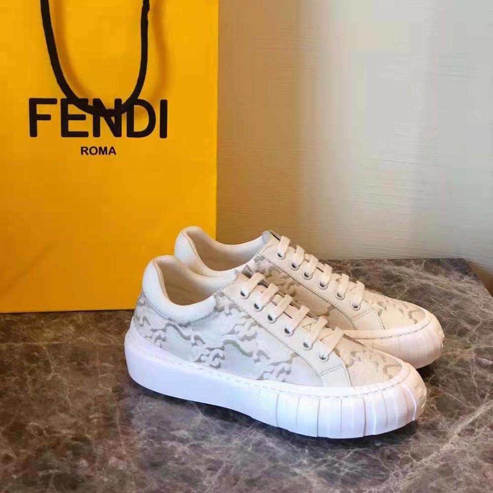 Close-up of embossed Fendi logo on white fabric sneaker