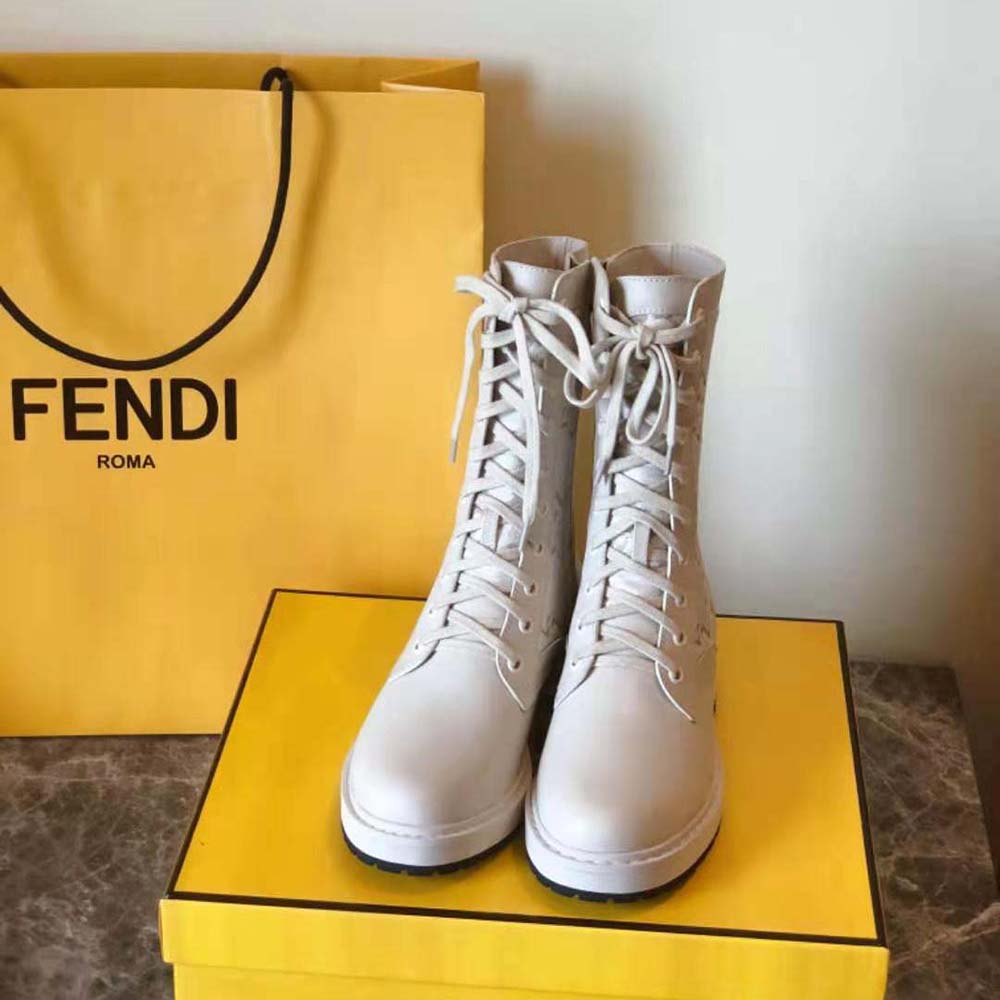 Close-up on gold-tone hardware detail of Fendi Women Signature White Leather Biker Boots