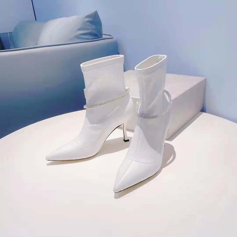 Side profile showing sleek stiletto heel of Jimmy Choo Leroy 90 boots