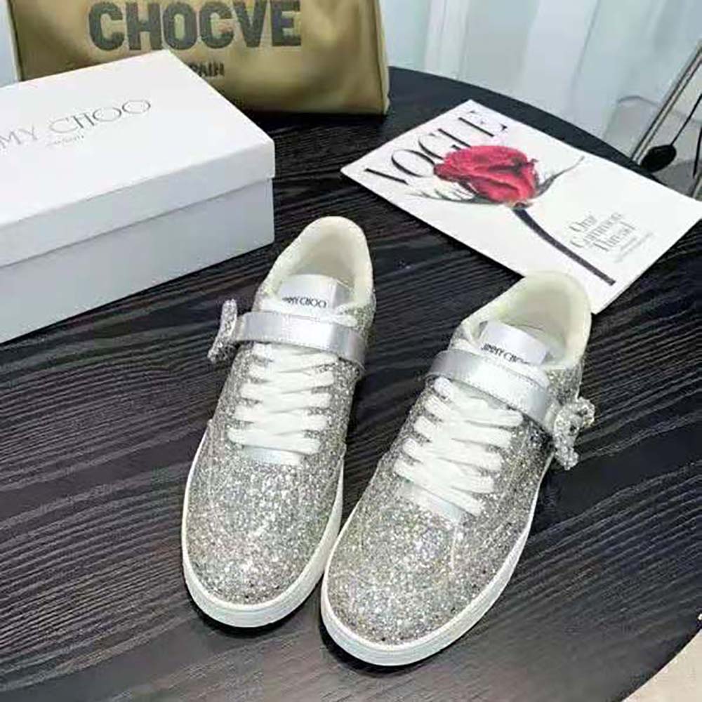 Close-up of shimmering silver coarse glitter fabric on Jimmy Choo Osaka trainers