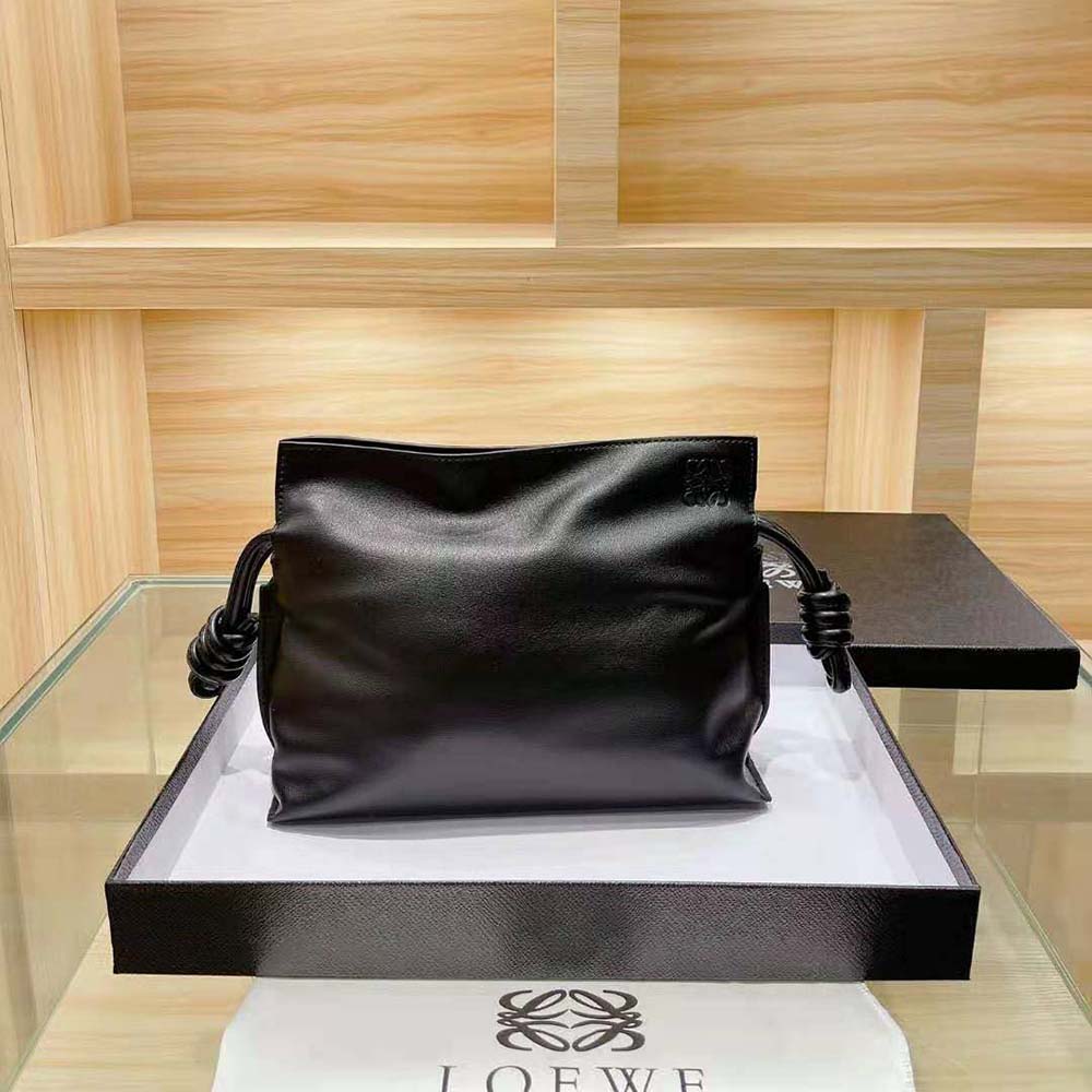 Close-up of brushed metal Loewe logo on Flamenco Clutch flap