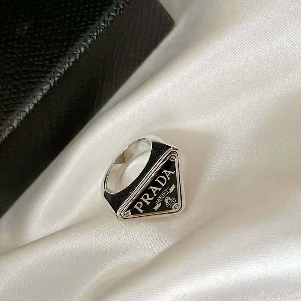 Top view highlighting polished silver and signature design of Prada Women 925 Sterling Silver with Enamel Symbole Ring