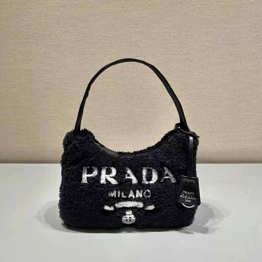 Close-up on silver-tone logo plaque of Prada Women Re-Edition 2000 Terry Mini-Bag-Black