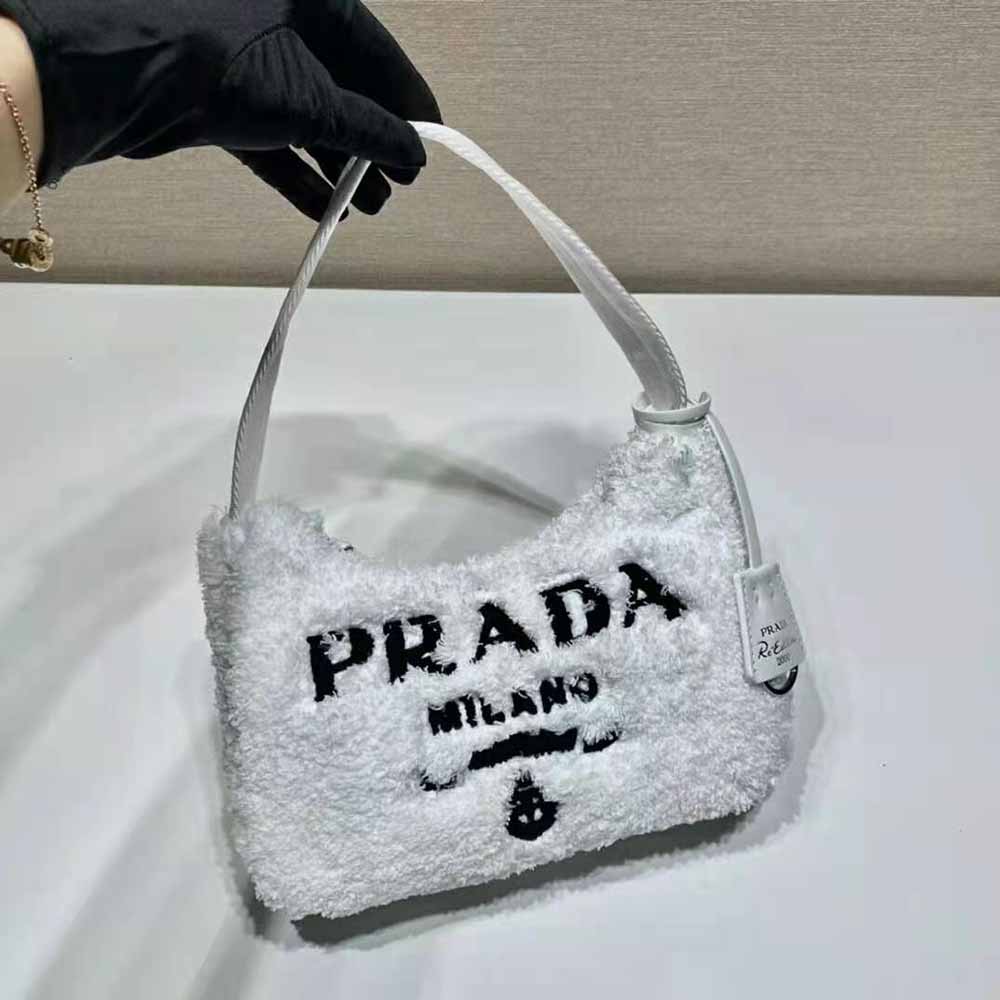 Side profile showing compact silhouette of Prada white shoulder bag