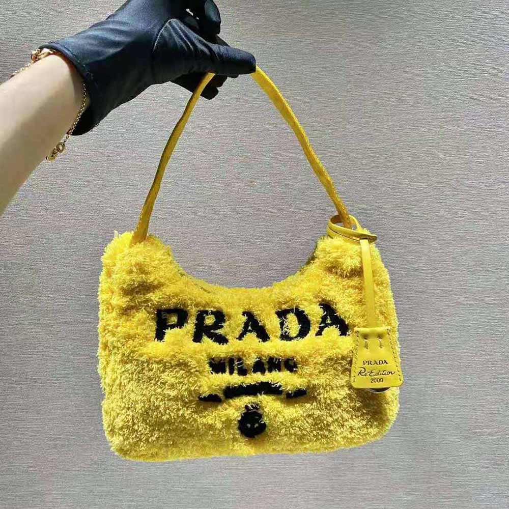 Close-up of silver Prada logo on yellow terry fabric mini-bag