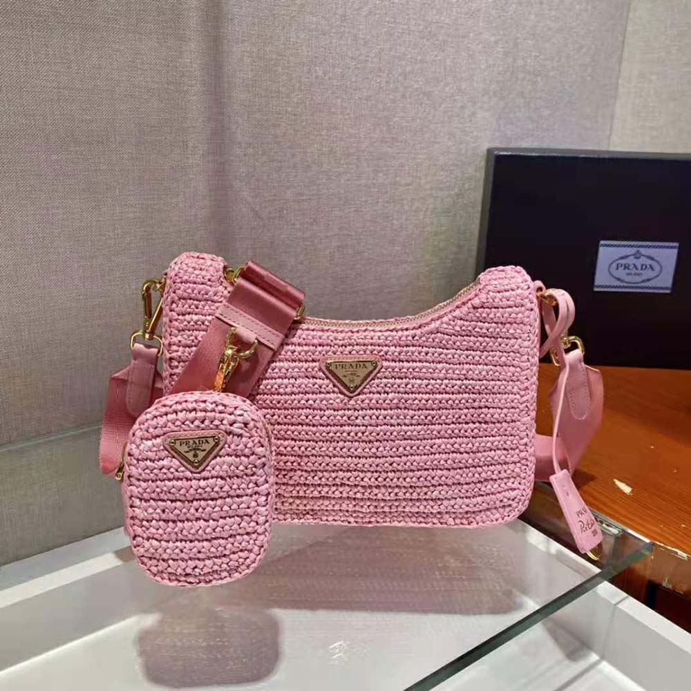Side angle of Prada Women Re-Edition 2005 Raffia Bag-Pink showing structured silhouette