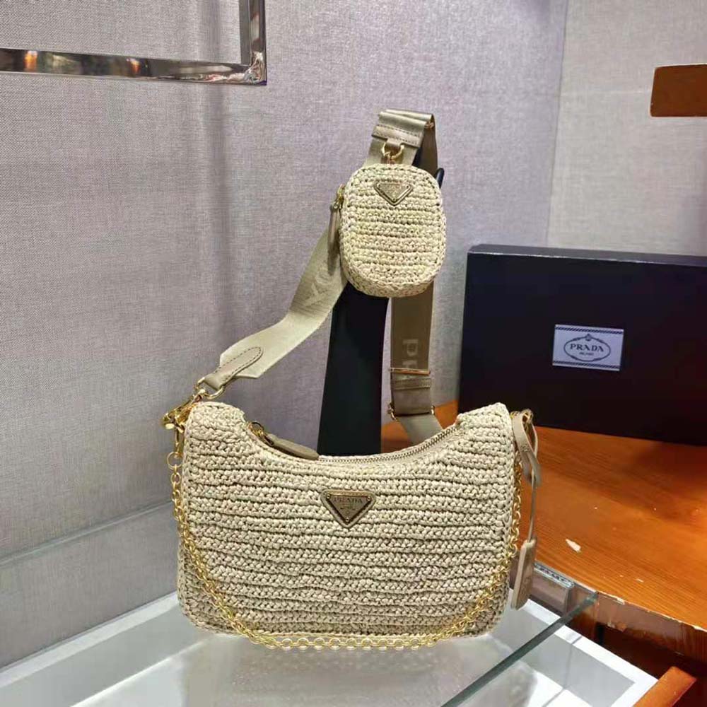 Close-up of gold-tone Prada logo plaque on Raffia Bag-Natural